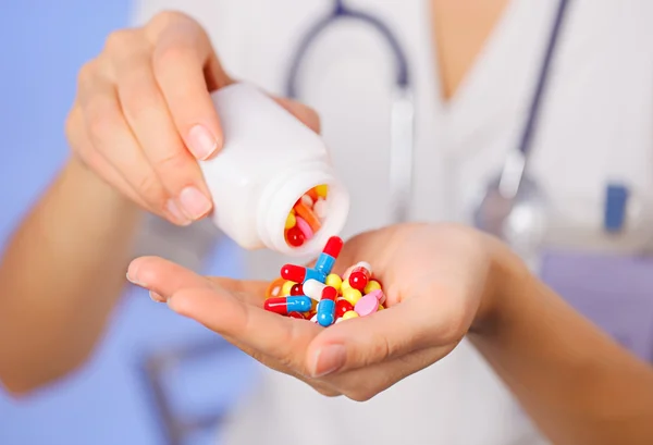 Таблетки, таблетки и препараты, наливание из бутылки в руке врача на — стоковое фото