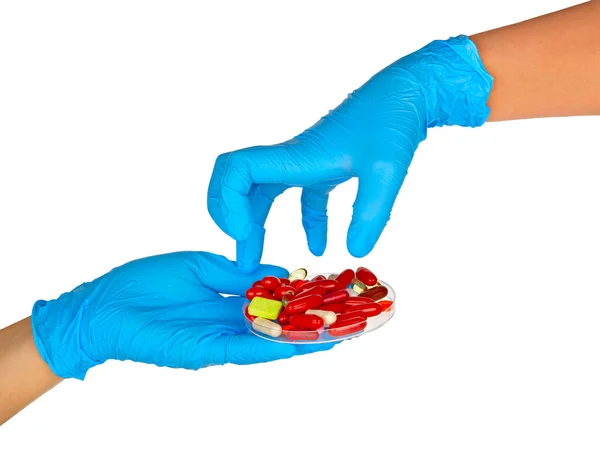 Перчатке с красочные таблетки — стоковое фото