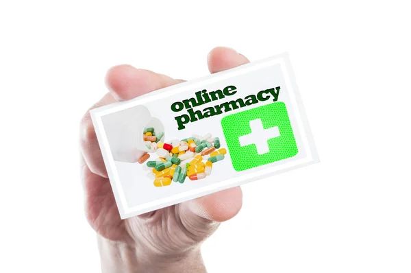 Рука карта с Интернет-аптеки, зеленый крест и таблетки — стоковое фото