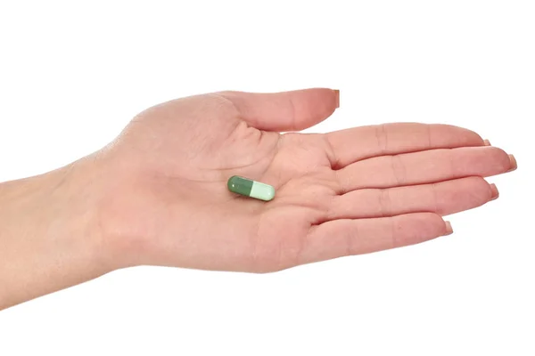 Женская рука с красочными таблетки, изолированные на белом — стоковое фото
