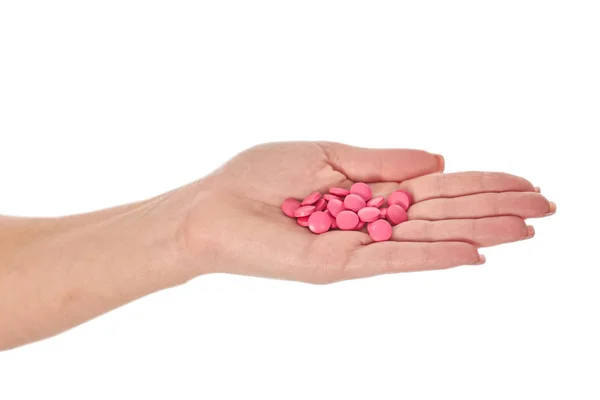 Женская рука с красочными таблетки, изолированные на белом — стоковое фото
