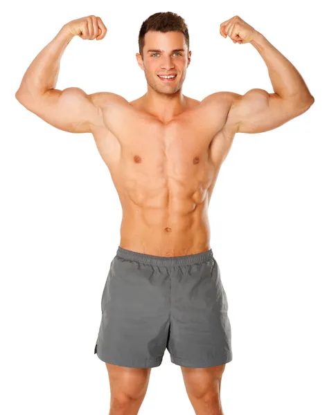 Соответствуйте и мускулистый человек, сгибающий его бицепс на белом — стоковое фото
